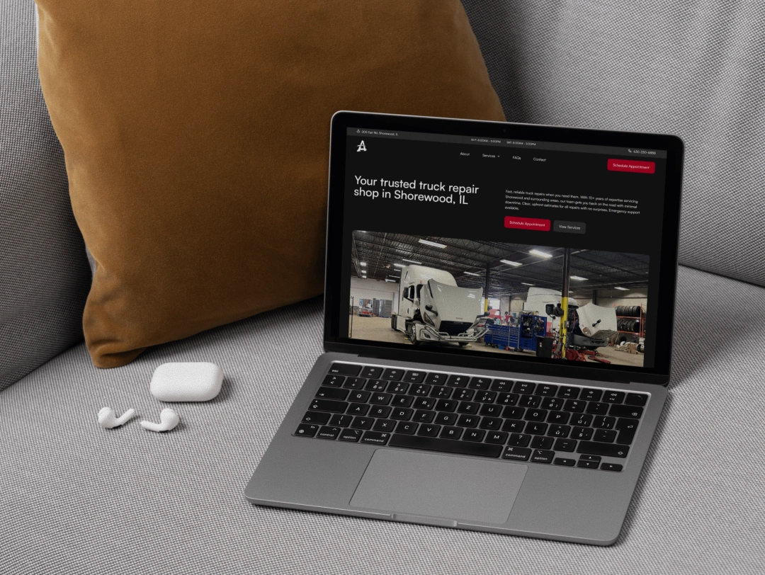 Alpha Truck Services website on laptop displaying truck repair services page