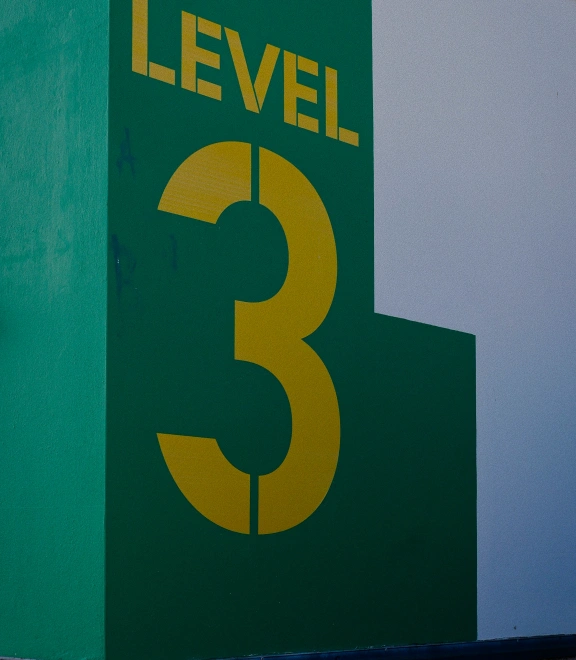 Building exterior showing directional signage with teal and yellow graphics