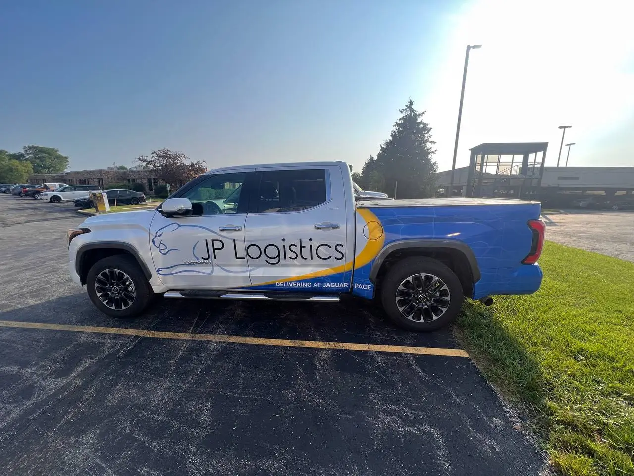 JP Logistics pickup truck with company branding